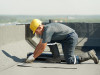 Flat roof covering works with roofing felt